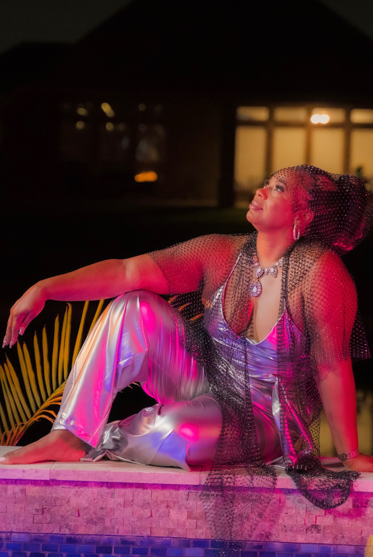 Tiffany Rachal poolside in silver jumpsuit — neon night shoot