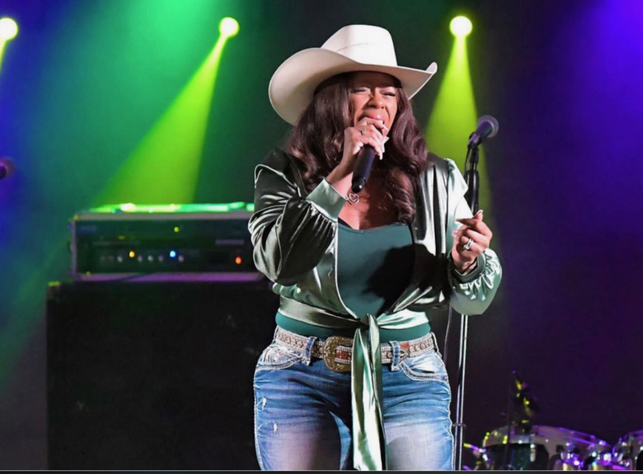 Tiffany Rachal performing live on stage in cowboy hat